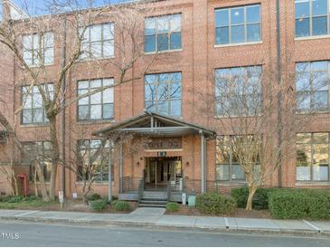 Elegant brick building entrance featuring covered entryway and well-maintained landscaping at 500 N Duke St # 55-103, Durham, NC 27701