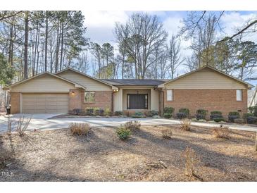 Charming single-story brick home with well-maintained landscaping and a spacious driveway at 6065 Merion Cir, Sanford, NC 27332