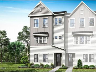 New construction townhome featuring a three-story design and charming architectural details on a professionally landscaped lot at 1024 Zelkova Lane, Chapel Hill, NC 27517