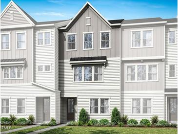 Charming townhouse with light gray and white exterior, manicured lawn, and welcoming entrance at 1026 Zelkova Lane, Chapel Hill, NC 27517