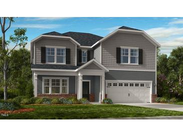 Charming two-story home with gray siding, black shutters, and well-manicured front yard at 109 Hiddenite Pl, Holly Springs, NC 27540