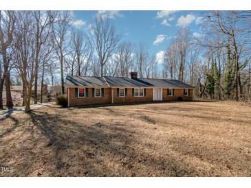 Charming one-story brick home featuring a well-maintained lawn and a classic architectural style at 1103 Driftwood Dr, Siler City, NC 27344