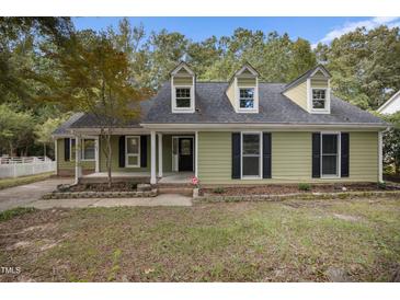 Charming exterior elevation with dormer windows and a cozy covered porch, offering great curb appeal at 1512 Maybrook Dr, Raleigh, NC 27610