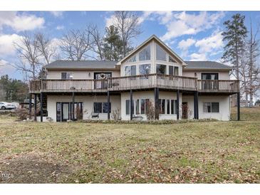 Multi-level home with a deck and lots of windows on a beautiful lot at 161 Kerr Lake Club Dr, Henderson, NC 27537