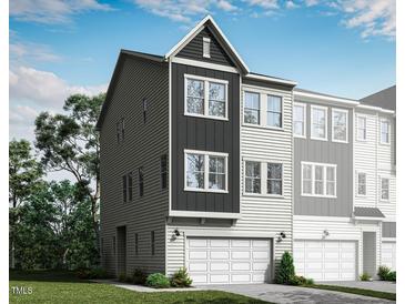 New two-story townhome with an attached two-car garage, modern architectural details, and neutral color palette at 2013 Trident Maple Ln, Chapel Hill, NC 27517