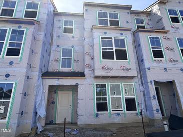 New construction townhomes featuring multiple windows and modern design elements at 319 Chesapeake Commons St # 103, Garner, NC 27529
