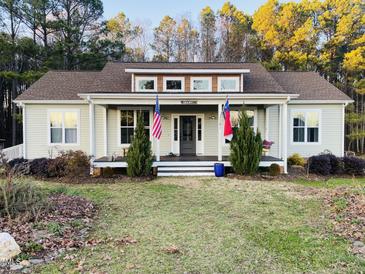 Charming home featuring a cozy front porch, fresh landscaping, and a welcoming entrance at 381 Reams Dr, Middlesex, NC 27557