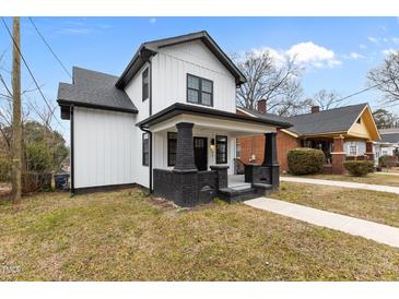 Charming two-story home with a classic white exterior, black trim, and inviting front porch at 405 N Hyde Park Ave, Durham, NC 27703