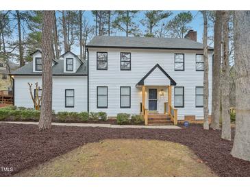 Charming two-story home with a beautifully landscaped front yard and inviting front porch at 4436 Talcott Dr, Durham, NC 27705