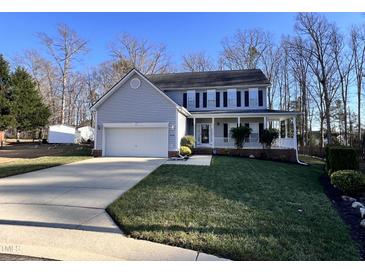 Charming two-story home with a covered front porch and a well-manicured lawn at 4904 Goosedown Ct, Raleigh, NC 27604