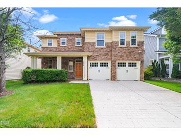 Charming two-story home featuring a stone facade, covered porch, and two-car garage at 532 Front Ridge Dr, Cary, NC 27519