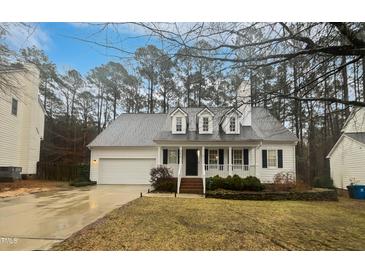 Charming one-story home featuring a welcoming front porch, dormer windows and attached garage at 206 Collegiate Cir, Durham, NC 27713