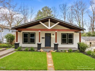 Charming bungalow showcasing a beautifully landscaped front yard and craftsman-style architecture at 2908 Woods Pl, Raleigh, NC 27607