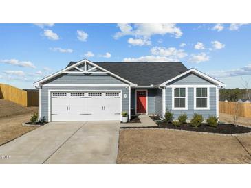 Charming single-Gathering home with a well-maintained front yard, garage, and a vibrant red front door at 45 Florentine Ct, Angier, NC 27501
