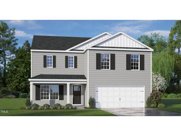 Charming two-story home with gray siding, black shutters, and a two-car garage at 100 Tobacco Woods Dr, Youngsville, NC 27596