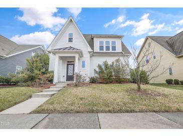 Charming two-story home with a manicured lawn, inviting entrance and classic architectural details at 1109 Hemby Ridge Ln, Morrisville, NC 27560