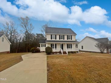 Charming two-story home with a welcoming front porch and well-maintained lawn at 1599 Rogers Pointe Ln, Creedmoor, NC 27522