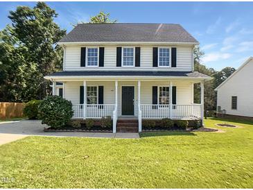 Charming two-story home featuring a welcoming front porch and well-manicured lawn at 1599 Rogers Pointe Ln, Creedmoor, NC 27522