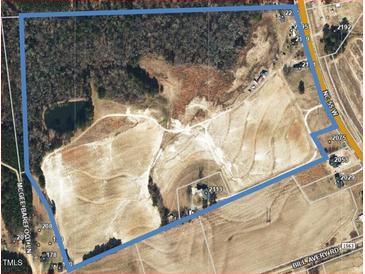 An aerial view showing the large property including trees and road access at 2113 Nc 55, Coats, NC 27521