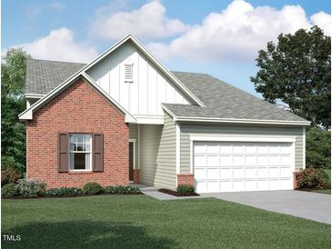 Charming single-Gathering home featuring a brick facade, attached garage, and well-maintained landscaping at 260 Logan Creek Dr, Zebulon, NC 27597