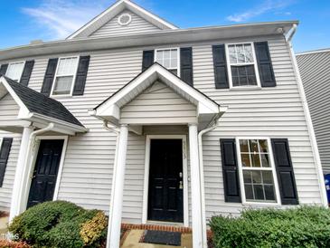 Charming two-story townhome with a welcoming front porch and black shutters at 5803 Osprey Cove Dr, Raleigh, NC 27604