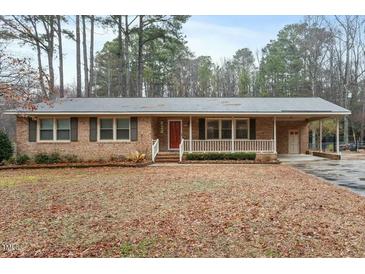 Charming brick home with a covered porch and a well-maintained front yard at 628 Stratford Dr, Zebulon, NC 27597