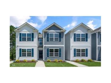 Charming two-story home with blue shutters, white trim, and a well-manicured lawn at 8641 Brixton Shay Dr, Raleigh, NC 27616