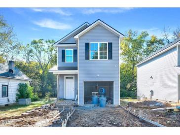 New two-story home showcasing gray siding, black shutters, and an attached garage at 102 Woodson St, Oxford, NC 27565