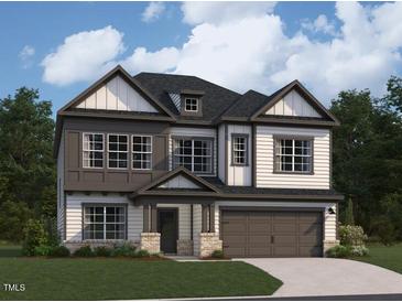 Two story home with gray trim, a large garage, and a covered front porch at 1404 Malcus Ct # 56, Fuquay Varina, NC 27526