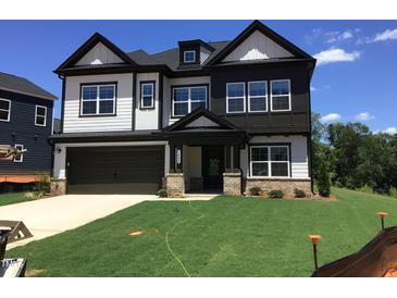 Beautiful new construction home with a two-car garage and manicured lawn at 1404 Malcus Ct # 56, Fuquay Varina, NC 27526