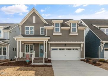 Charming two-story home features a covered porch, two-car garage, and welcoming curb appeal at 1721 Birdhaven Ln, Wendell, NC 27591