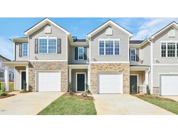 Charming townhomes feature stone accents and private garage entries at 1909 Frost Dr, Haw River, NC 27258