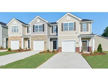 Charming townhomes featuring durable siding, stone accents, and attached garages, perfect for comfortable and stylish living at 1910 Frost Dr, Haw River, NC 27258