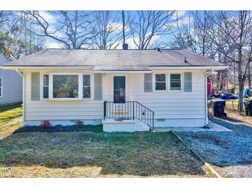 Charming single-story home with white siding, black trim, and well-maintained front yard at 210 Monk Rd, Durham, NC 27704
