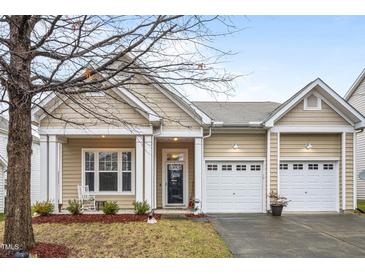 Charming single-story home features a two-car garage, front porch with columns, and well-maintained landscaping at 2815 Mebane Ln, Durham, NC 27703
