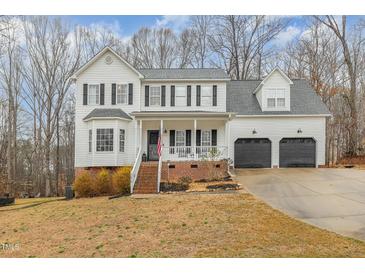 Charming two-story home with a welcoming front porch and well-manicured lawn at 296 Trenburg Pl, Clayton, NC 27520