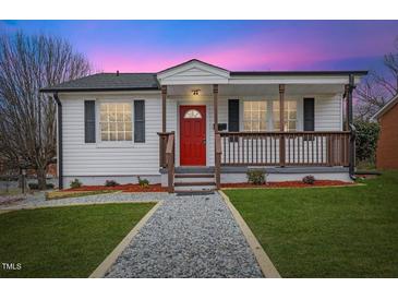 Charming single-story home featuring a welcoming porch and well-maintained front yard with a red front door at 318 Fulton St, Burlington, NC 27217