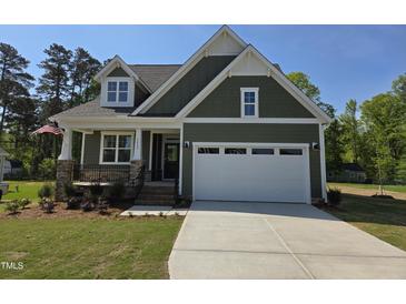 Charming one-story home with a two-car garage, covered porch and landscaped front yard at 5849 Genesee Dr., Homesite 3, Durham, NC 27712
