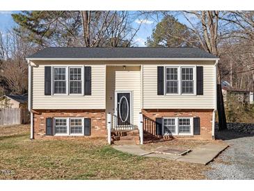 Charming two-story home featuring a brick foundation and classic black shutters at 7 Misty Creek Ct, Durham, NC 27705