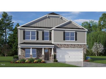 Charming two-story home with stone accents, a well-manicured lawn, and a two-car garage at 78 Fair Child Rd, Spring Lake, NC 28390