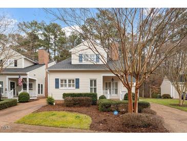 Charming two-story home with light siding, blue shutters, and a well-manicured front yard at 800 Mill Greens Ct, Raleigh, NC 27609