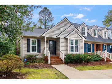 Charming single-Gathering home featuring a well-manicured lawn, inviting front porch, and classic architectural details at 101 Heatherwood Dr, Apex, NC 27502