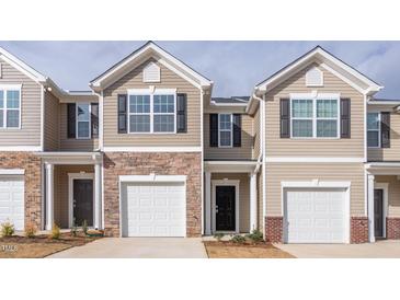 Inviting townhouse with a one-car garage and appealing stone and siding facade at 1912 Frost Dr, Haw River, NC 27258
