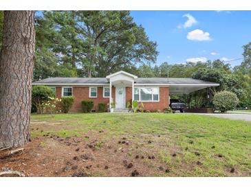 Charming brick home featuring a covered carport and well-maintained front yard at 2732 Old Milburnie Rd, Raleigh, NC 27604