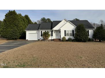 Charming, single-story home features a well-manicured lawn, attached garage and mature landscaping at 305 River Birch Run, Coats, NC 27521