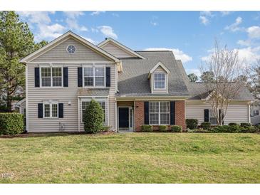 Charming two-story home with a well-manicured lawn, classic architecture, and dark shutters at 9510 Dellbrook Ct, Raleigh, NC 27617