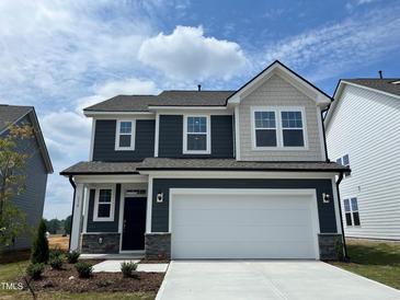 Charming two-story home with a two-car garage, craftsman details, and manicured landscaping at 116 Willow Cameron Way, Angier, NC 27501