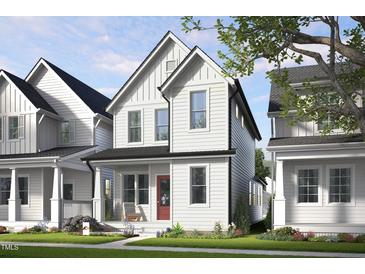 Charming two-story home with white siding, a red door, and a cozy front porch at 1907 Plott Balsam Dr, Wendell, NC 27591