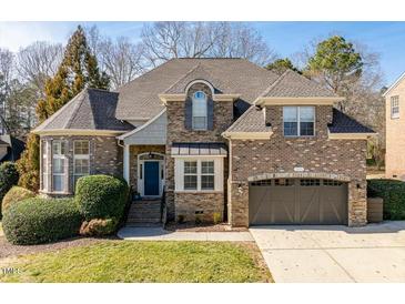 Charming two-story brick home with manicured landscaping and a two-car garage at 3025 Osterley St, Raleigh, NC 27614