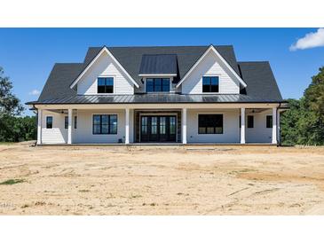 Stunning new construction home with a welcoming front porch and modern farmhouse design at 6509 Zebulon Rd, Wake Forest, NC 27587